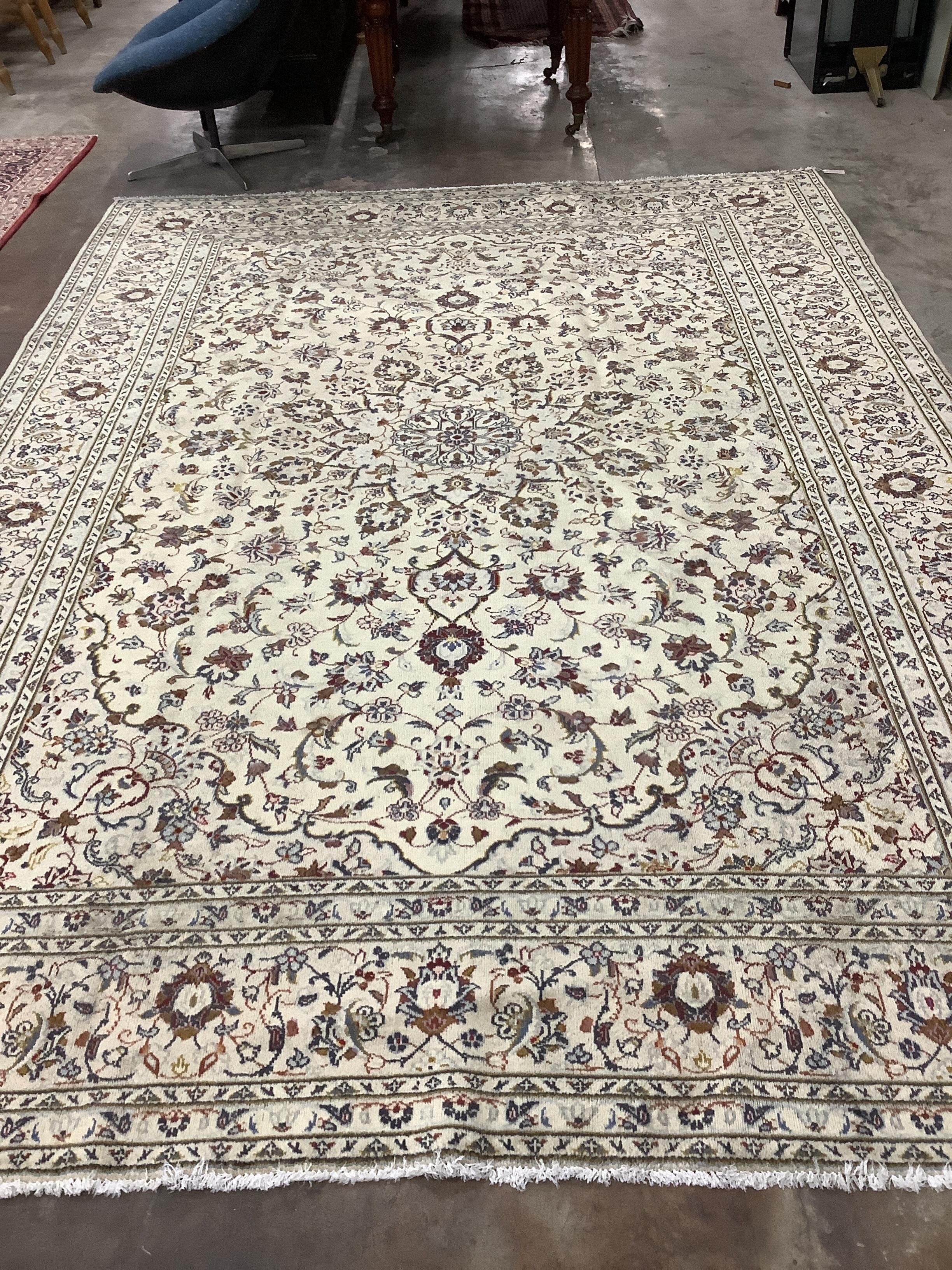 A Kashan ivory ground carpet, 345 x 245cm
